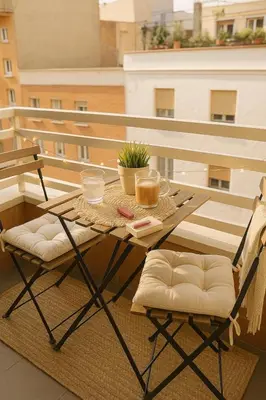 a table and two chairs on a balcony at Del Mar three bed flat. in Puerto de Sagunto