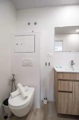 a white bathroom with a toilet and a sink at Nautical Flats by Concept in Valencia