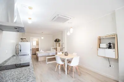 a kitchen and living room with a table and chairs at Nautical Flats by Concept in Valencia