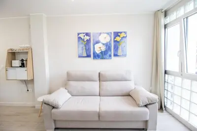 a white couch in a living room with a window at Nautical Flats by Concept in Valencia