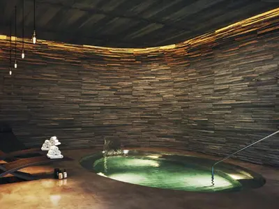 a room with a pool with a teddy bear next to a brick wall at Apartment Gran Canet by Interhome in Canet de Berenguer