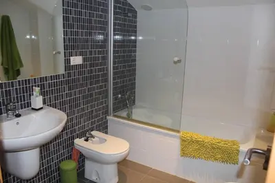 a bathroom with a toilet and a sink and a shower at Confortable Beach Appartment with Views to the Sea in Puzol