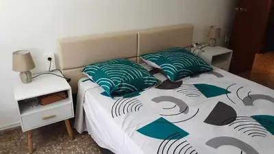 a bedroom with a bed with two pillows on it at Villa les palmiers in Rafelguaraf
