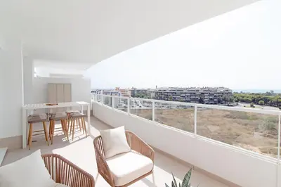 a room with a balcony with a table and chairs at Gran Apartment in Canet de Berenguer