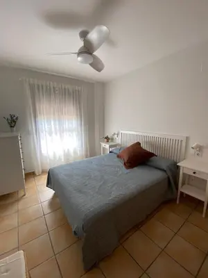a bedroom with a bed and a ceiling fan at Residencial Playa Canet in Canet de Berenguer