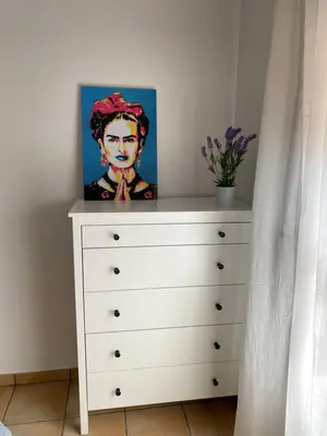 a painting sitting on top of a dresser at Residencial Playa Canet in Canet de Berenguer