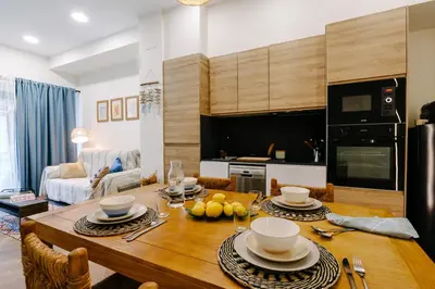 a kitchen and living room with a wooden table at La Peregrina in Valencia