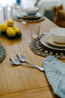 a wooden table with spoons and dishes on it at La Peregrina in Valencia