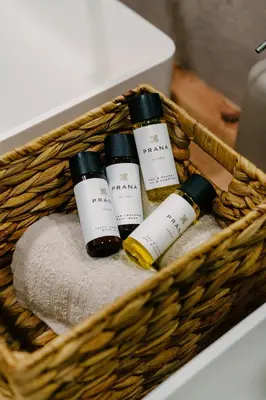 a basket with three bottles of wine and towels at La Peregrina in Valencia