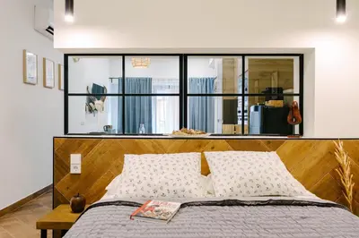 a bedroom with a bed with a large window at La Peregrina in Valencia