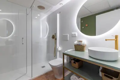 a bathroom with a sink and a shower at Apartamentos Las Ciencias H in Valencia