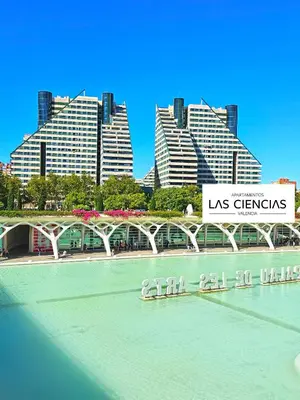 a bridge over a river with buildings in the background at Apartamentos Las Ciencias H in Valencia