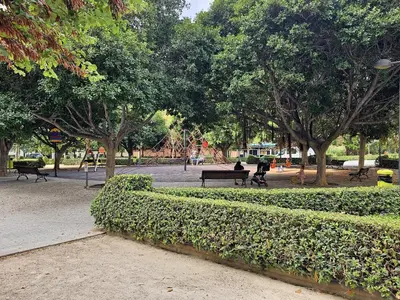 a park with benches and trees in a park at Apartamentos Las Ciencias A in Valencia