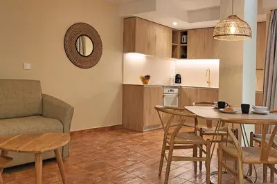 a living room with a table and chairs and a kitchen at Apartamentos Las Ciencias A in Valencia