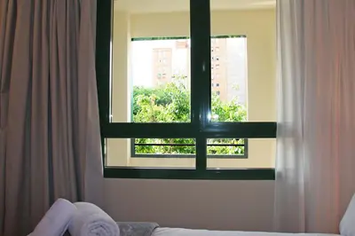 a window in a room with a bed and a window at Apartamentos Las Ciencias F in Valencia