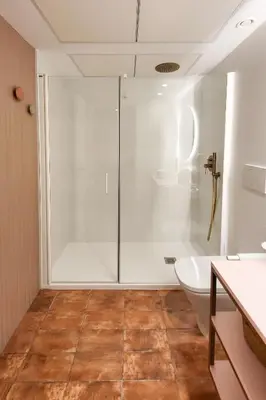 a bathroom with a glass shower and a toilet at Apartamentos Las Ciencias F in Valencia