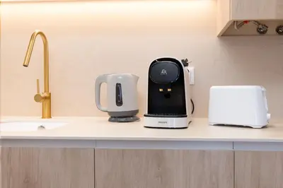 a kitchen counter with a coffee maker and a toaster at Apartamentos Las Ciencias I in Valencia
