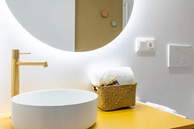 a bathroom with a round sink and a mirror at Apartamentos Las Ciencias I in Valencia