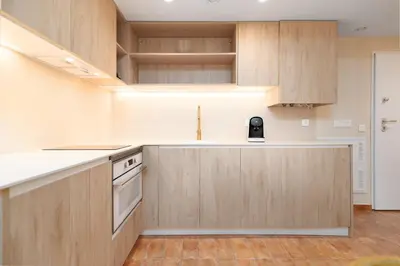 a kitchen with wooden cabinets and a counter top at Apartamentos Las Ciencias I in Valencia