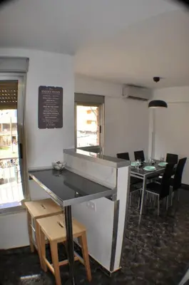 a dining room with tables and chairs and a counter at Spacious, 2 BR/2 BA, 3 Min walk to the beach in Cullera