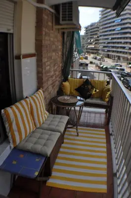 a balcony with a couch and a table on a balcony at Spacious, 2 BR/2 BA, 3 Min walk to the beach in Cullera