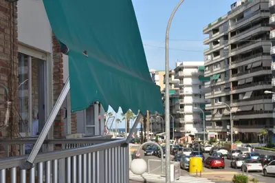 a green awning on a balcony of a building at Spacious, 2 BR/2 BA, 3 Min walk to the beach in Cullera