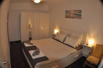 a bedroom with a large bed and a chair at Spacious, 2 BR/2 BA, 3 Min walk to the beach in Cullera