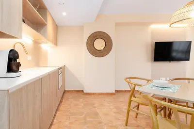 a kitchen and dining room with a table and chairs at Apartamentos Las Ciencias K in Valencia
