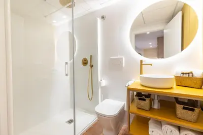 a bathroom with a shower and a sink and a mirror at Apartamentos Las Ciencias K in Valencia