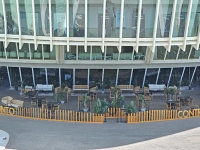 a building with tables and chairs in front of it at Apartamentos Las Ciencias K in Valencia