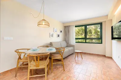 a living room with a table and chairs and a couch at Apartamentos Las Ciencias L in Valencia