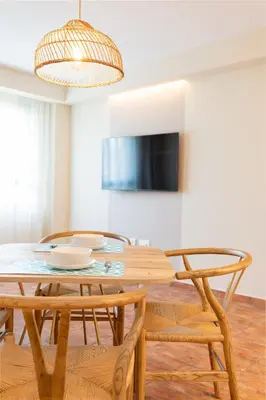 a dining room with a table and two chairs at Apartamentos Las Ciencias L in Valencia