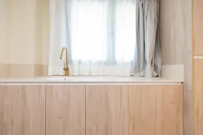 a window with a white curtain and a sink at Apartamentos Las Ciencias S in Valencia