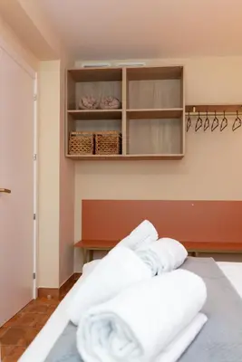 a bedroom with white towels on a bed at Apartamentos Las Ciencias S in Valencia