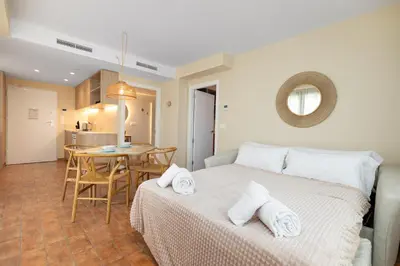 a bedroom with a bed and a table in a room at Apartamentos Las Ciencias S in Valencia