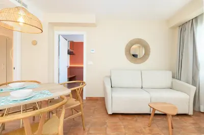 a living room with a table and a couch at Apartamentos Las Ciencias S in Valencia