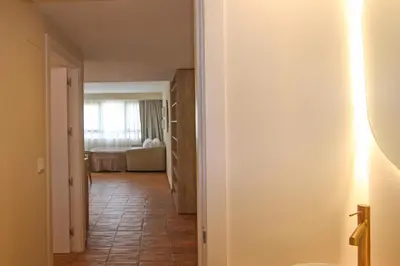 a hallway with a room with a bed and a light at Apartamentos Las Ciencias E in Valencia