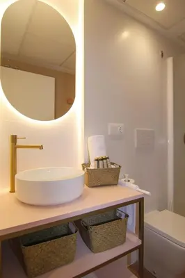 a bathroom with a sink and a mirror at Apartamentos Las Ciencias E in Valencia