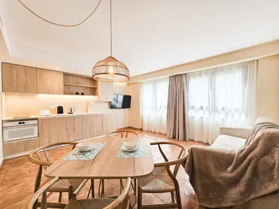 a kitchen and living room with a table and chairs at Apartamentos Las Ciencias Studio N in Valencia