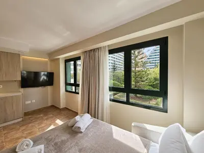 a bedroom with a bed and a large window at Apartamentos Las Ciencias Studio N in Valencia