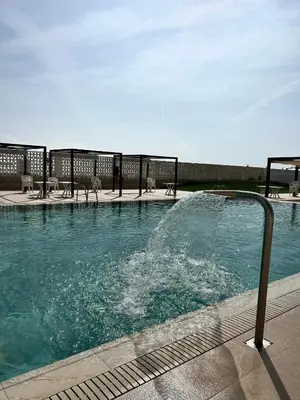 a swimming pool with a fountain in the middle at Mareny de Barraquetes in Mareny Blau