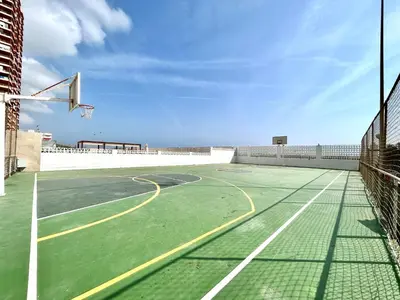 a basketball court with a net and a hoop at Mareny de Barraquetes in Mareny Blau