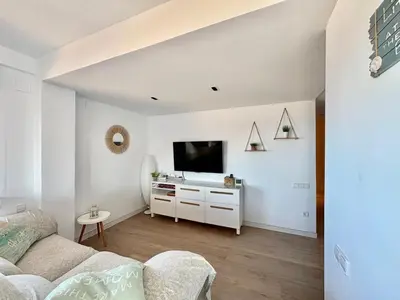 a living room with a couch and a flat screen tv at Mareny de Barraquetes in Mareny Blau
