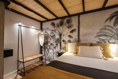 a bedroom with a bed and a wall with a mural at Precioso Loft en Valencia in Valencia