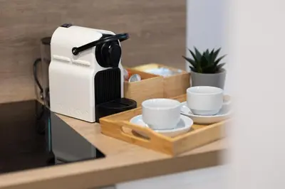 a coffee maker and two cups on a wooden tray at DormForYou Alameda 12 Apartment in Valencia
