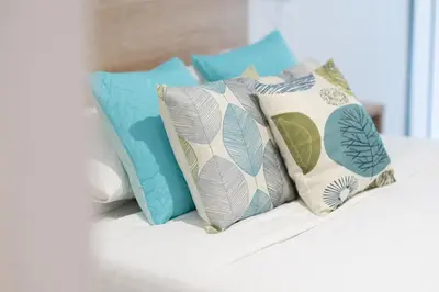 a bunch of pillows sitting on a bed at DormForYou Alameda 12 Apartment in Valencia