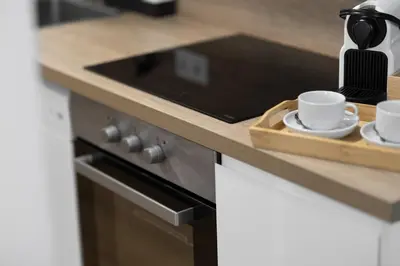 a kitchen counter with two cups and a cutting board at DormForYou Alameda 12 Apartment in Valencia