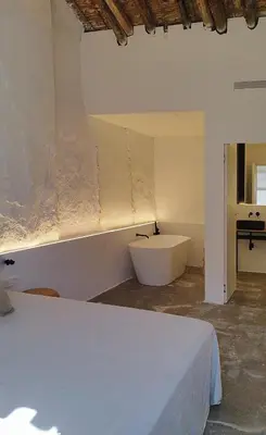 a bedroom with a bed and a bath tub in it at Casa cristo 37 navarrés in Navarrés