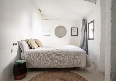 a bedroom with a bed in a white room at Casa cristo 37 navarrés in Navarrés