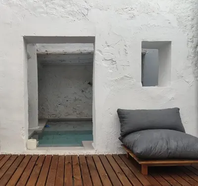 a couch sitting on a wooden floor next to a wall at Casa cristo 37 navarrés in Navarrés